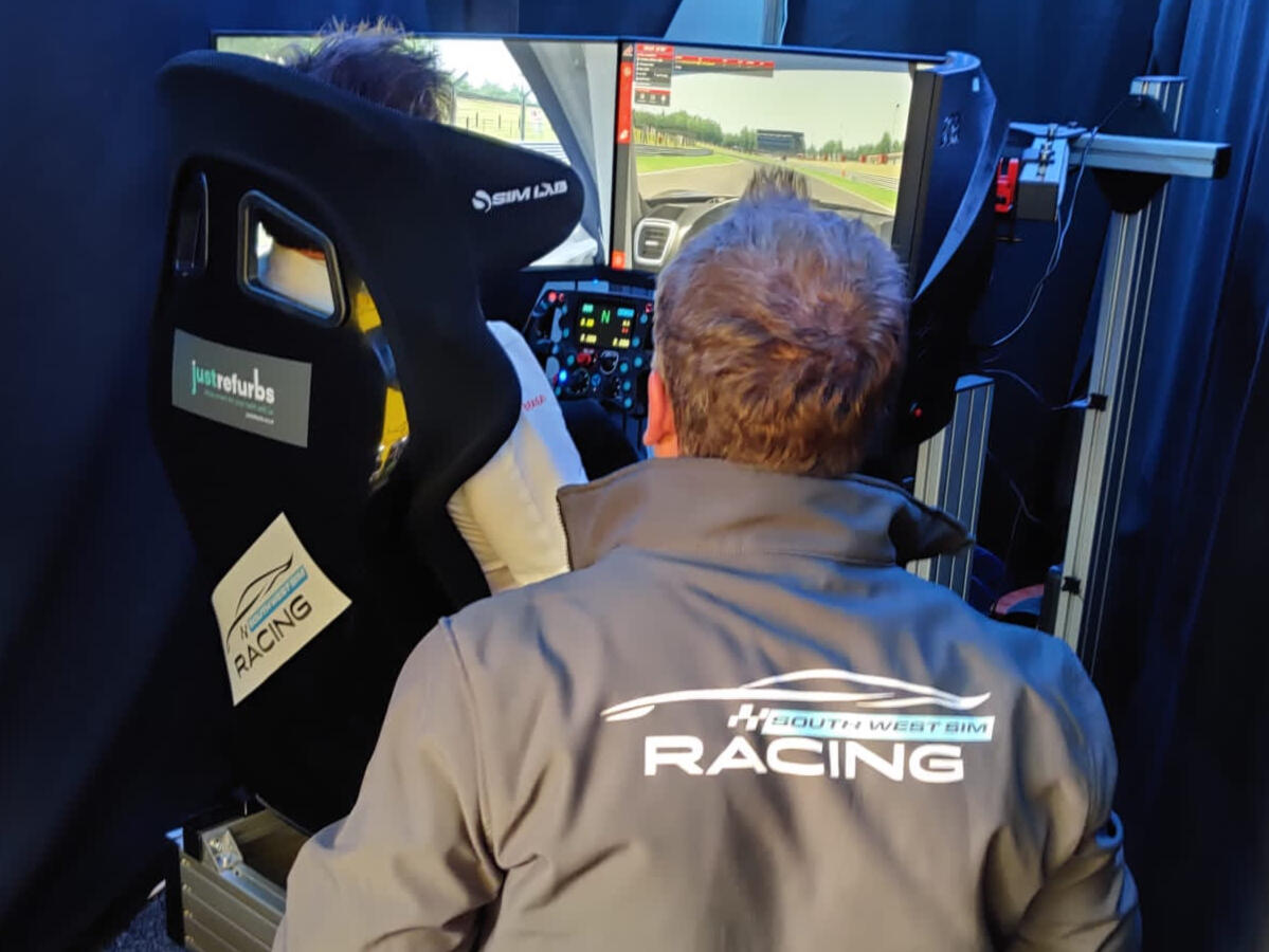Person driving the South West Sim Racing rig with export tuition. Person driving the South West Sim Racing rig with export tuition.
