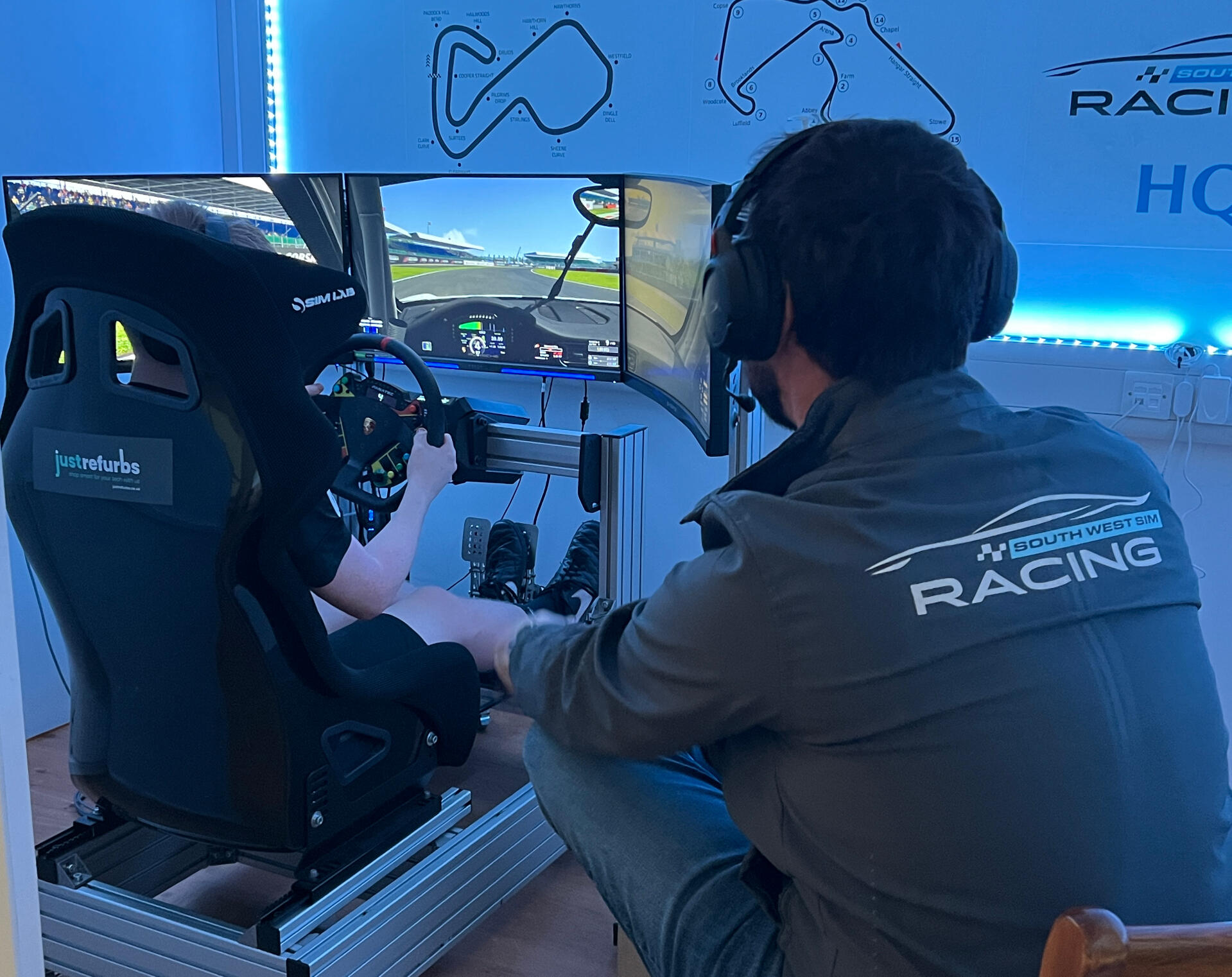 Person driving the South West Sim Racing rig with professional instructor. Person driving the South West Sim Racing rig with professional instructor.